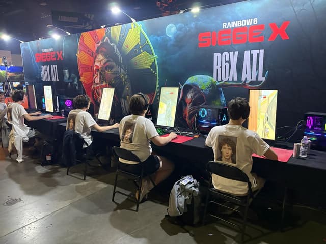 Branded game activation booth with players at a convention