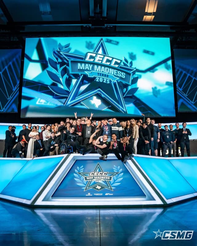 Student teams on stage under a championship screen