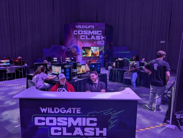 Game demo booth with players at a convention